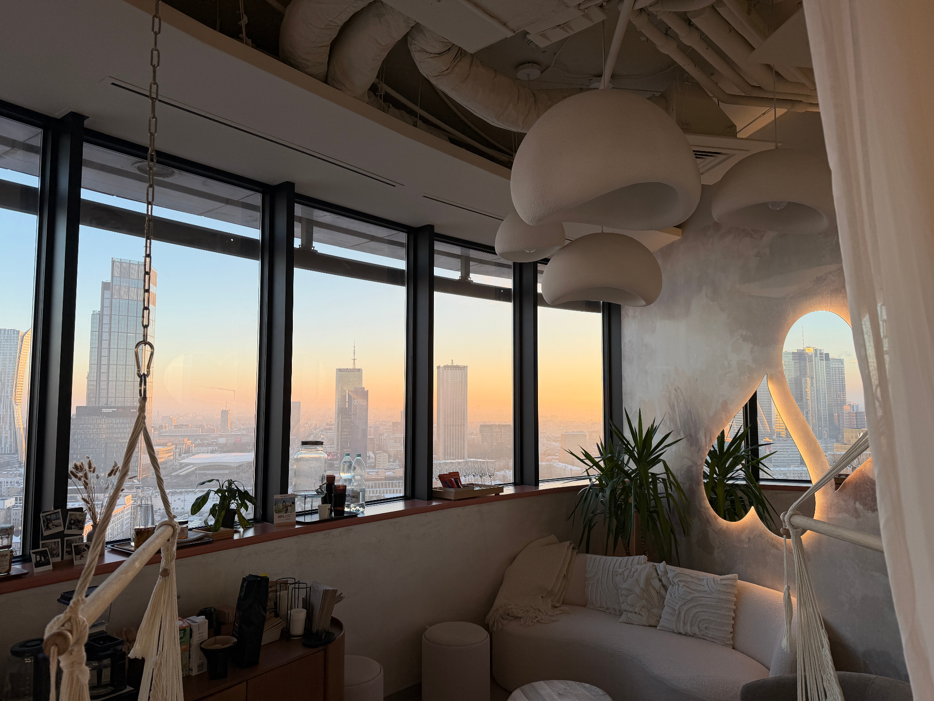 Strefa relaksu BeShaped z panoramą Warszawy o zachodzie słońca z 24. piętra Atlas Tower